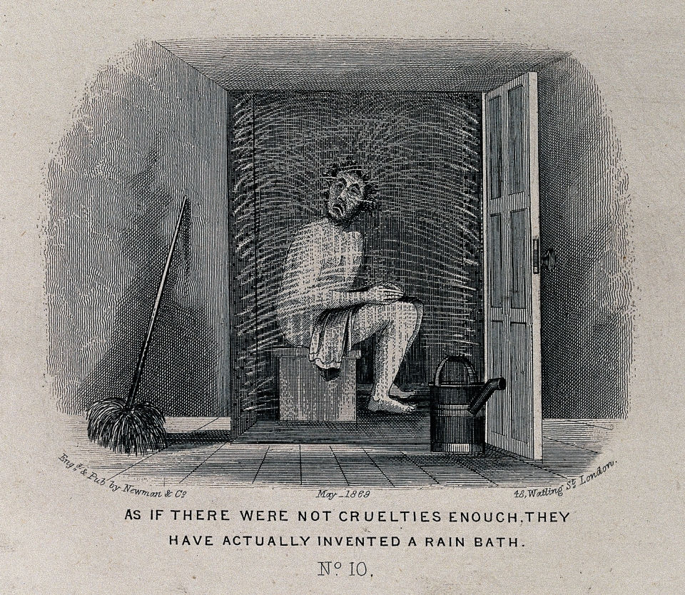 A man seated in a cubicle is being sprayed with water Welcome